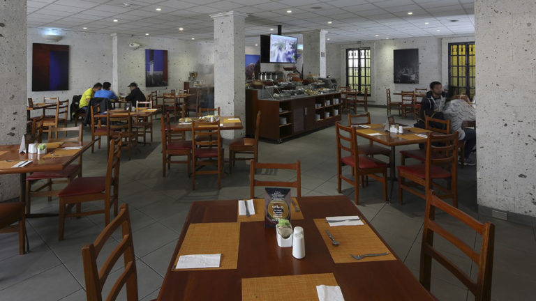 Tables and chairs are set at the Sama Restaurante Café, offering Peruvian and international fusion cuisine for breakfast, lunch and dinner at the Casa Andina Standard Arequipa in Peru.