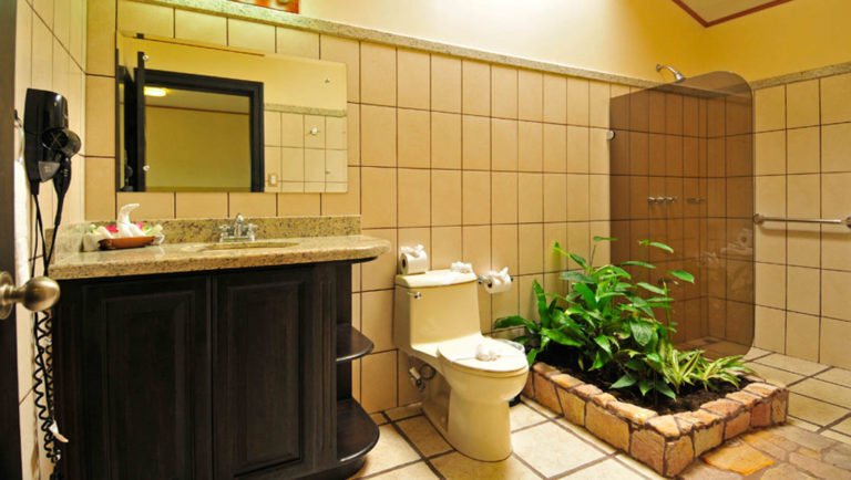 The tiled bathrooms are decorated with plants at the sustainable Arenal Manoa Lodge in Costa Rica