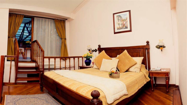 An extra large double bed in a room at the Hotel Patio Andaluz in Quito, Ecuador, located near the Plaza de la Independencia