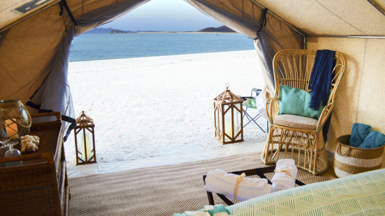 The ocean and a white sand beach are just outside the glamping tents at Camp Cecil de la Isla on Isla Espiritu Santo