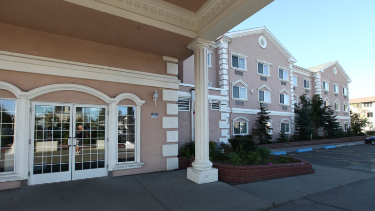 Main entrance and ample parking outside Clarion Suites in Anchorage
