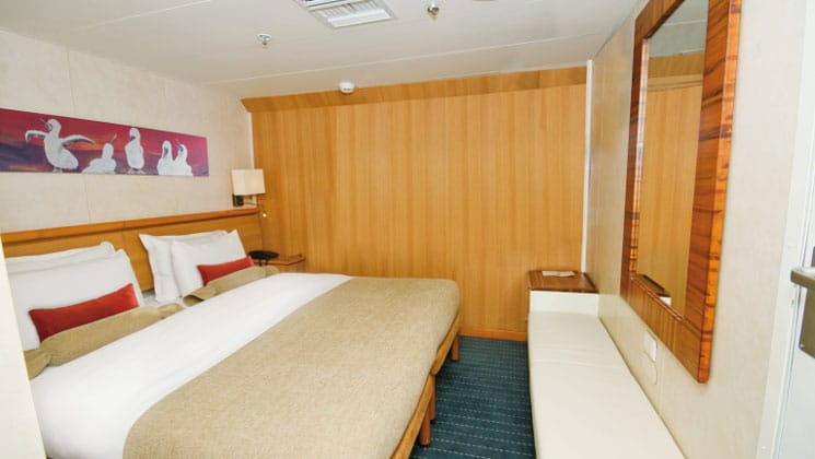 Standard Interior cabin aboard Galapagos Legend small ship, with 2 twin beds, 2 lamps and no window or porthole.