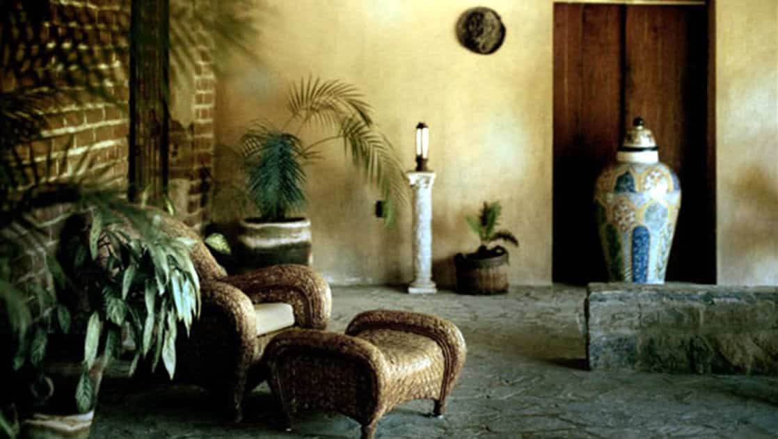 Artwork, plants, and chairs on the patio at Todos Santos Inn, an old hacienda hotel in Baja