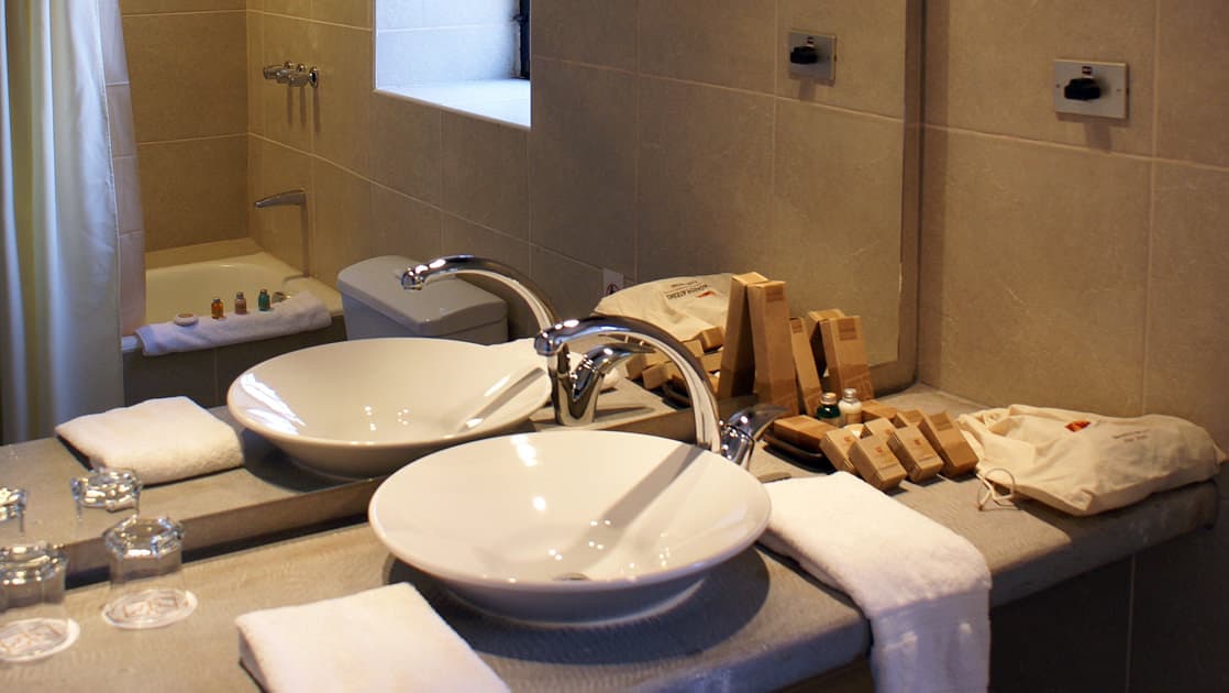 A sink on the counter with a mirror inside the bathroom at Sonesta Posadas Del Inca in Peru's Sacred Valley, a boutique hotel near Machu Picchu.