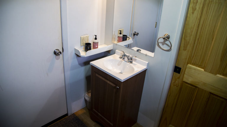 Sink, counter, and mirror in cabin aboard Ursus.