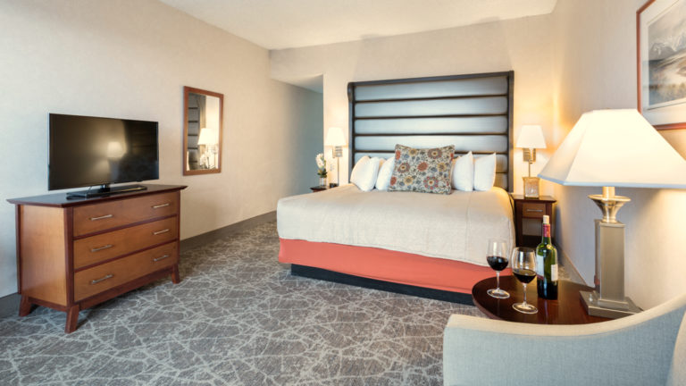 A standard room with a king-sized bed, television, and sitting area at the Westmark Anchorage, a downtown hotel that was recently renovated