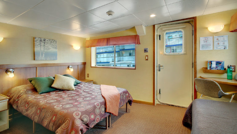 Admiral cabin with queen bed aboard Wilderness Discoverer