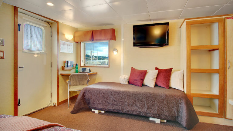 Day bed to accommodate a third person in the Admiral cabin aboard Wilderness Discoverer
