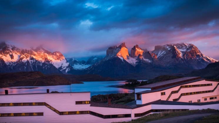 Purple alpenglow hues in the sky as the sun sets on Explora Patagonia Lodge in Chile