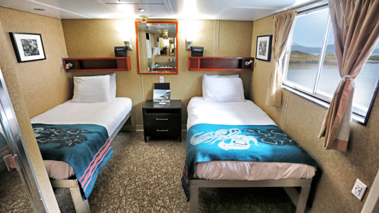 Category AAA stateroom with two twin beds and large window aboard Admiralty Dream
