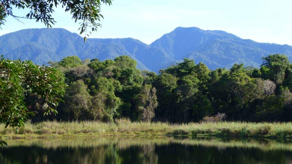 volcan lagoons in panama with trees behind them and large mountains in the background