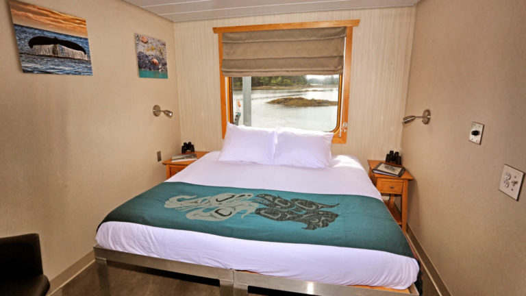 Category AAA stateroom aboard Chichagof Dream with bed and window.