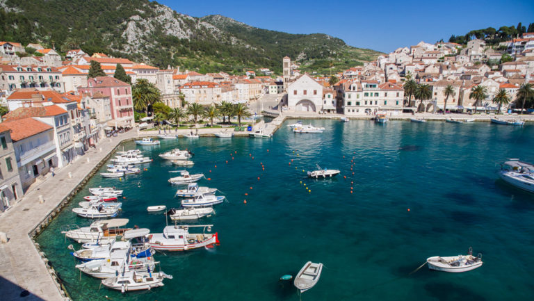 hvar harbor on the dalmatian coast in croatia filled with yachts and small ships atop the beautiful mediterranean, during the day.