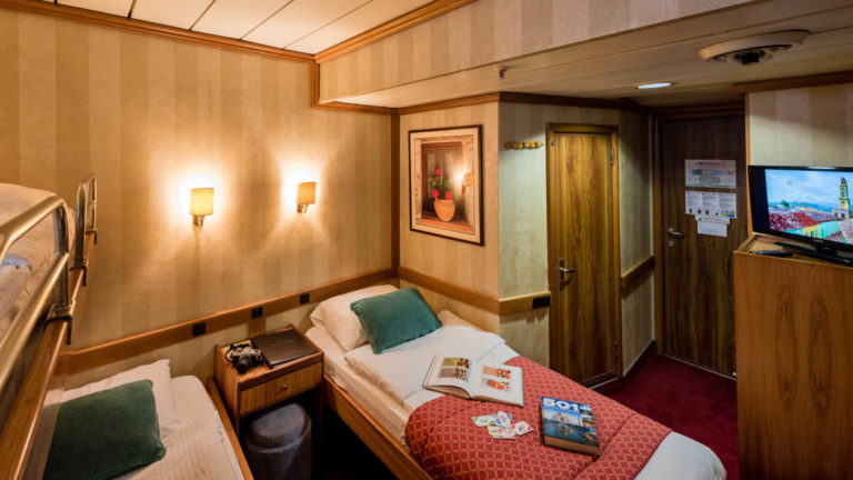 panorama Mediterranean yacht room with three beds and a picture on the wall