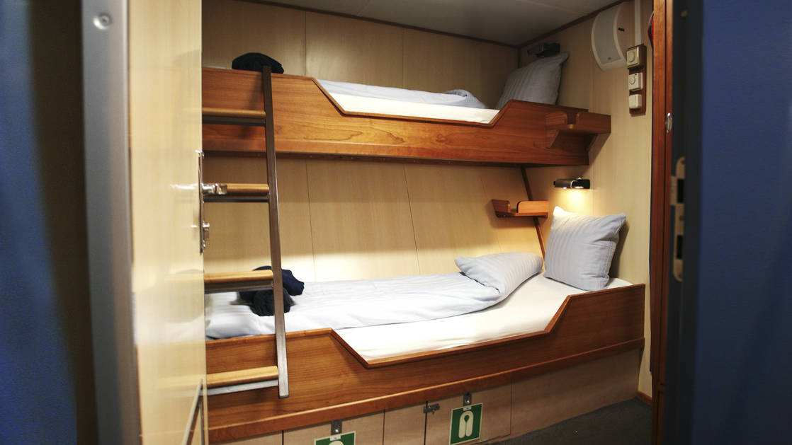 cabin with bunk beds and a ladder aboard the Rembrandt van Rijn arctic small ship