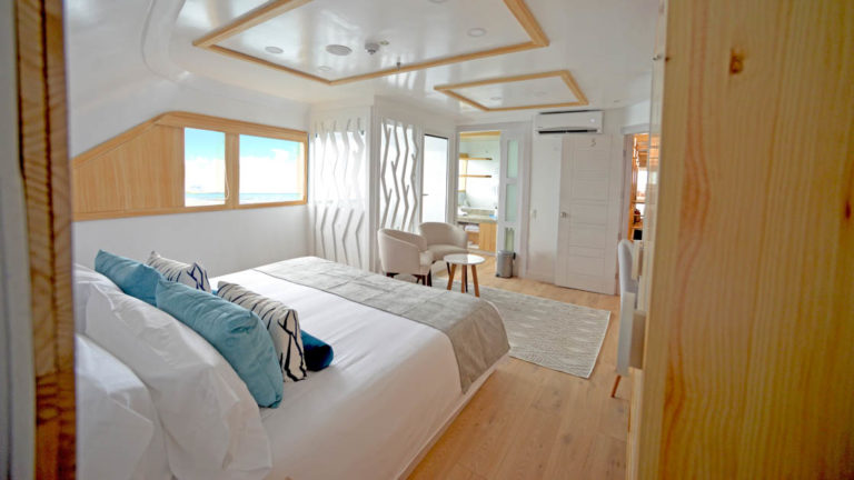 Main Deck Suite aboard Sea Star Journey. Bird's eye view of bed with balcony.