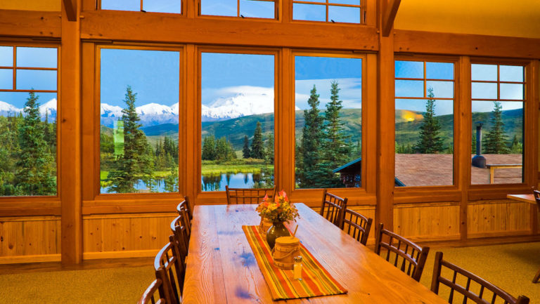 Wooden tables and chairs with fresh flowers and big windows boasting views of Denali National Park are where guests eat Alaska-grown meat and produce, including wild fish, pork, elk and reindeer products.