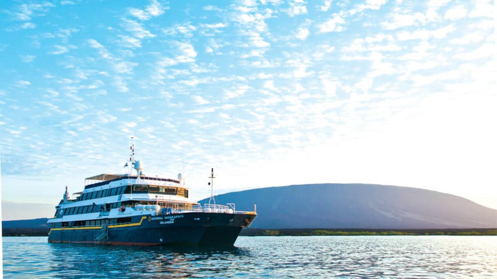 Full exterior of starboard side and bow of National Geographic Islander expedition ship in Galapagos Islands