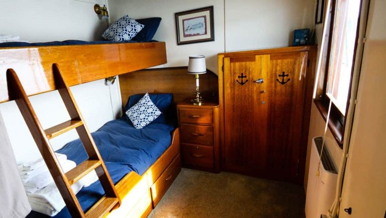 Twin bunk beds, nightstand, dresser in Stateroom 3 aboard Sea Wolf yacht in Alaska