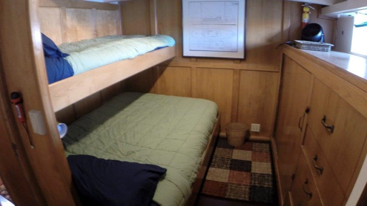 westward cabin 3 with large bed and twin bunk bed, cupboards and window
