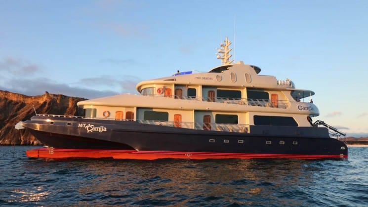 The exterior of the Camila Galapagos Cruise during sunset as it motors on the ocean