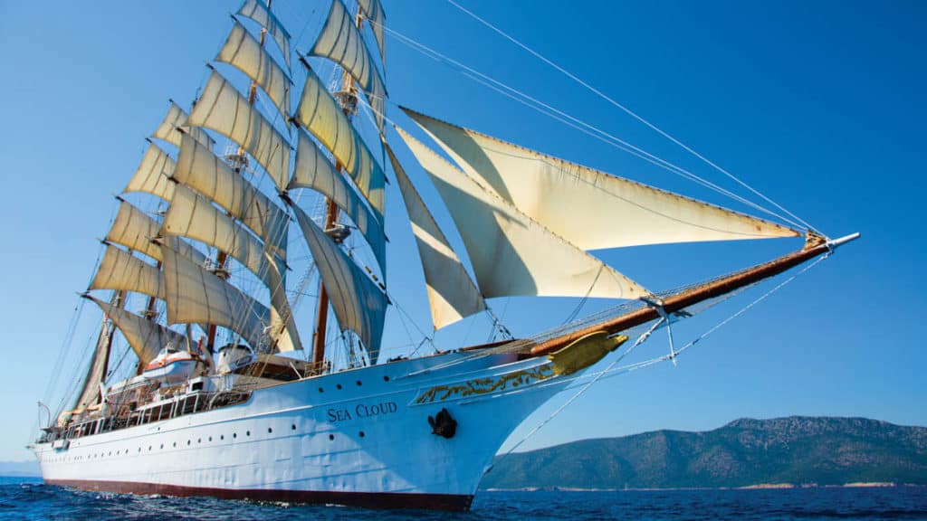 The Sea Cloud under full sail seen from in front of the bow