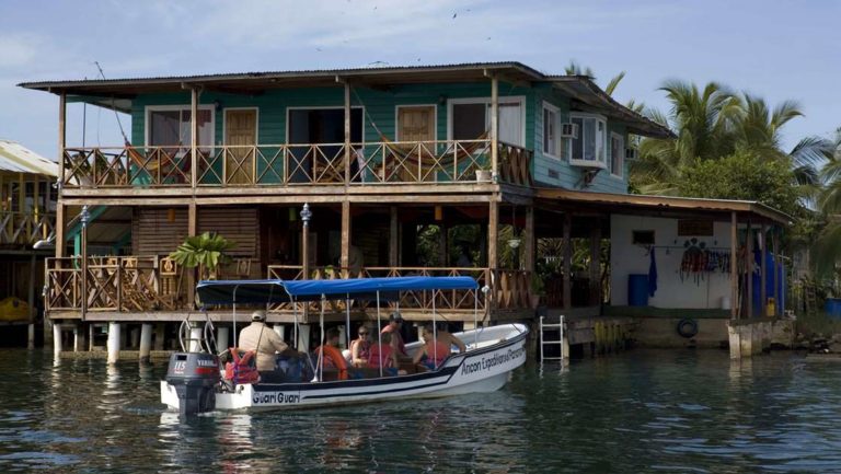 Bocas del Toro lodge right on the water with boats pulling up to the deck in Panama