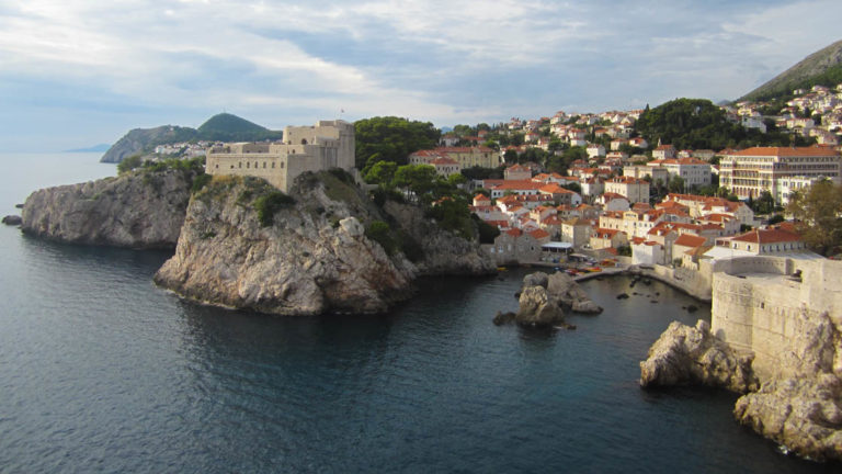 Seaside town in croatia with fortress walls on the cliffs by the water