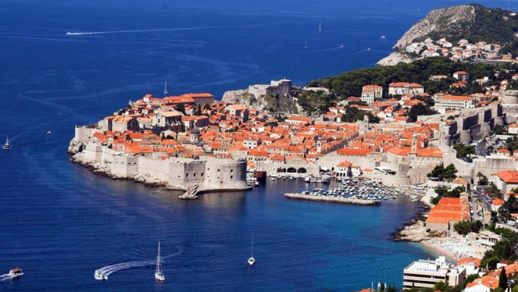 A view of dubrovnik with red tiled roofs and a harbor in the adriatic sea