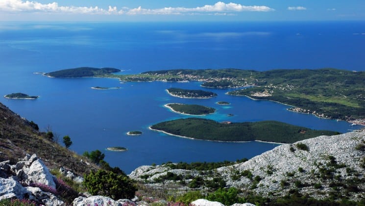 Islands in the adriatic sea with lush green plants and rocky bluffs