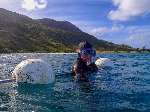 A child snorkeler relaxing at a resting station in the Great Barrier Reef