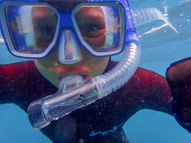 A child scuba diving in the Great Barrier reef