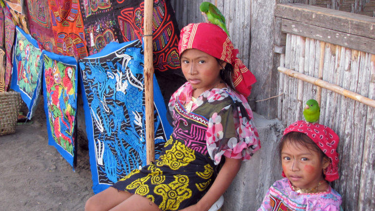Two young girls in traditional outfits from the Guna Yala culture in Panama