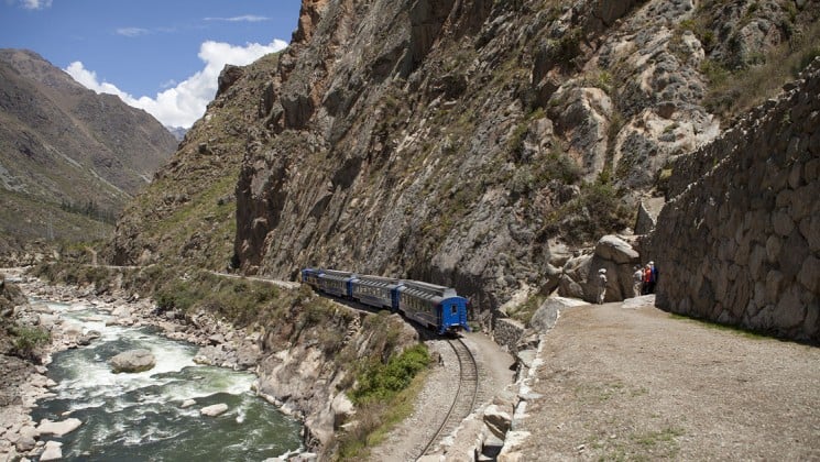 train beside river in mountains on inca trail trek land tour in peru