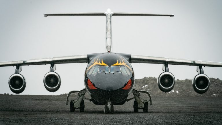 Front of small dark jet with penguin painted face used on Polar Circle Air Cruise.