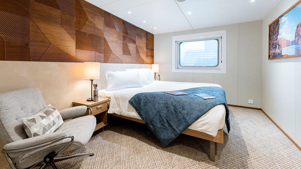Promenade Deck Stateroom with junior king bed aboard Coral Geographer