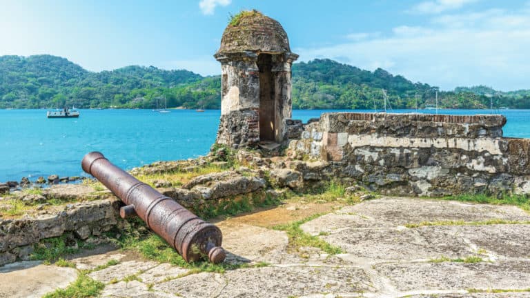 Old Spanish cannon at the fortress ruin of Santiago with a view over the Caribbean Sea in Portobelo near Colon, Panama.