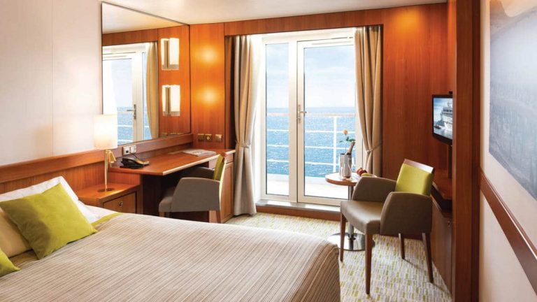 Veranda Stateroom aboard M/S Seaventure, with queen bed, desk, TV & balcony.