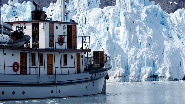 Historic yacht Catalyst close to glaciers in Glacier Bay National Park, Alaska.