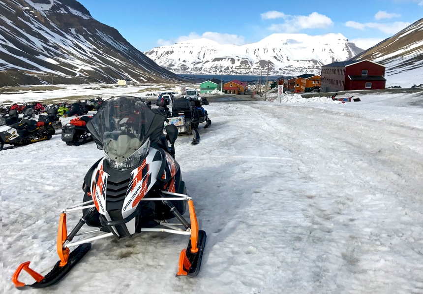 A fleet of snowmobiles sit on the snow in the town of Longyearbyen on Spitsbergen Island in Norway's Svalbard archipelago.
