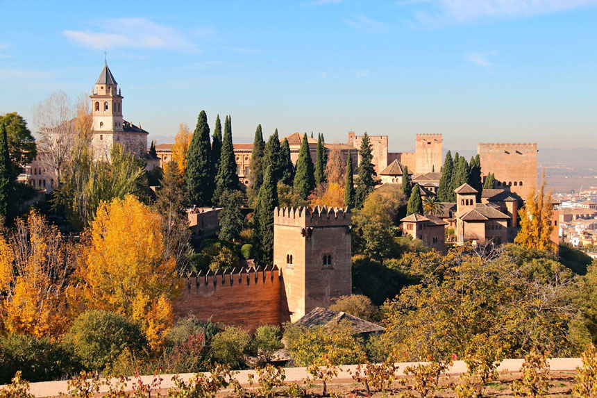 Overlooking beige, turreted stone castles & a vineyard near the Alhambra in Granada, Spain