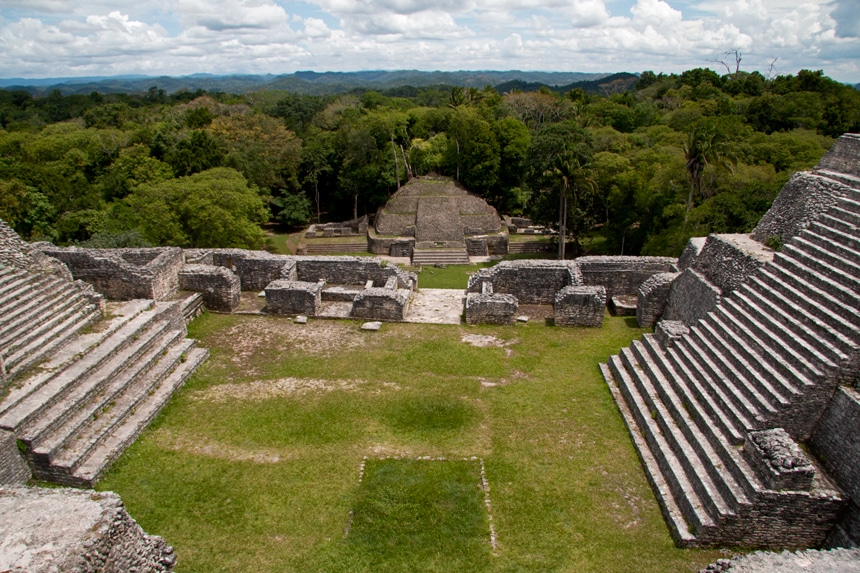 A sprawling archeological site of an old Mayan city made of limestone, found tucked away inside a dense lush green forest in Belize. 