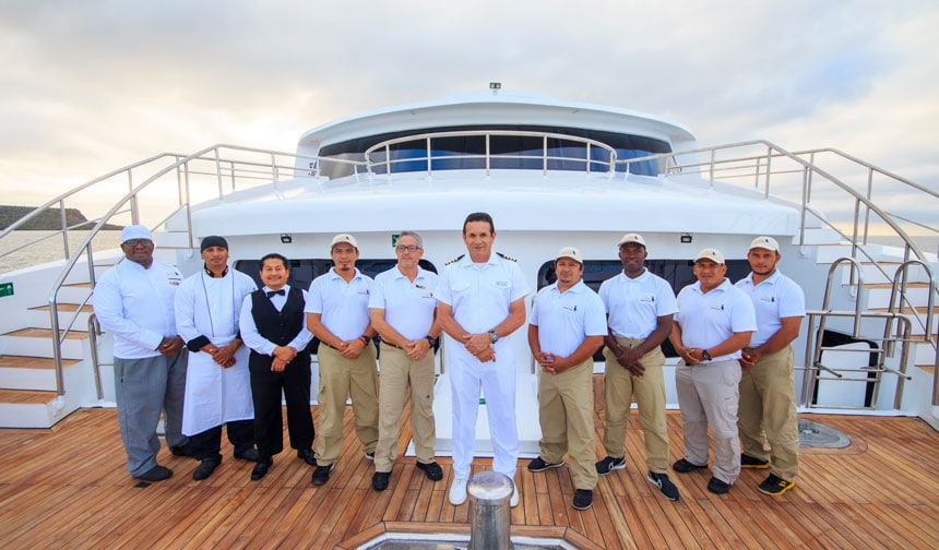 Sailing crew of Elite catamaran standing on deck during a Galapagos Islands yacht charter.