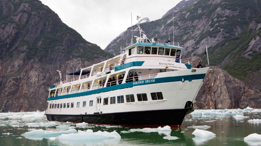 Bow of Baranof Dream cruising in Alaskan fjords with ice around.