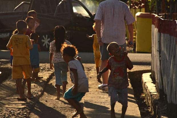 Group of happy small children playing on the street in a Indonesian town.