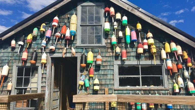 Traditional Maine lobster shack with lobster cage buoys adorning its exterior, in Bar Harbor, Maine.