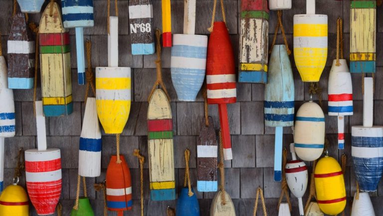 Multicolored buoys hang against a house in Provincetown, Massachusetts, seen on a cruise from New York to Boston.